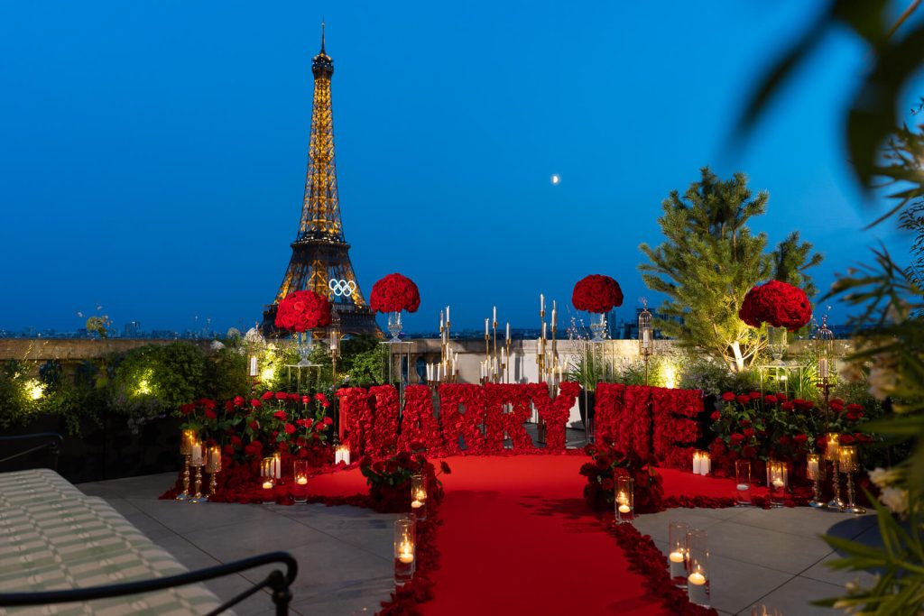 Luxurious "Marry Me" proposal on Shangri-La Paris rooftop. Red carpet, thousands of red roses, and Eiffel Tower view.