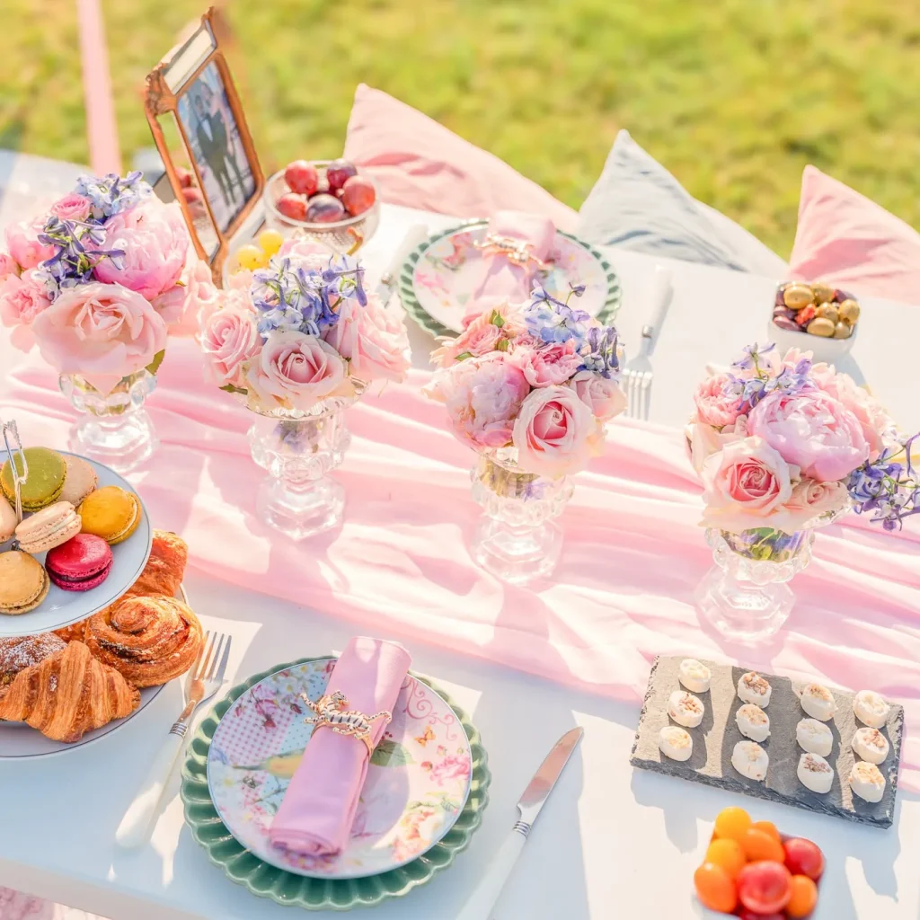 Romantic Paris picnic proposal at Trocadéro with Eiffel Tower view, pastel pink theme, floral vases, sushi, pastries, and cozy pillows