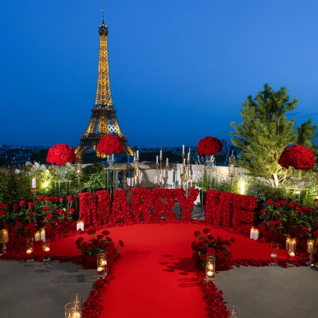 Luxury rooftop proposal at Shangri-La Paris with red 'Marry Me' letters, real roses, candlelit decor, and Eiffel Tower night view