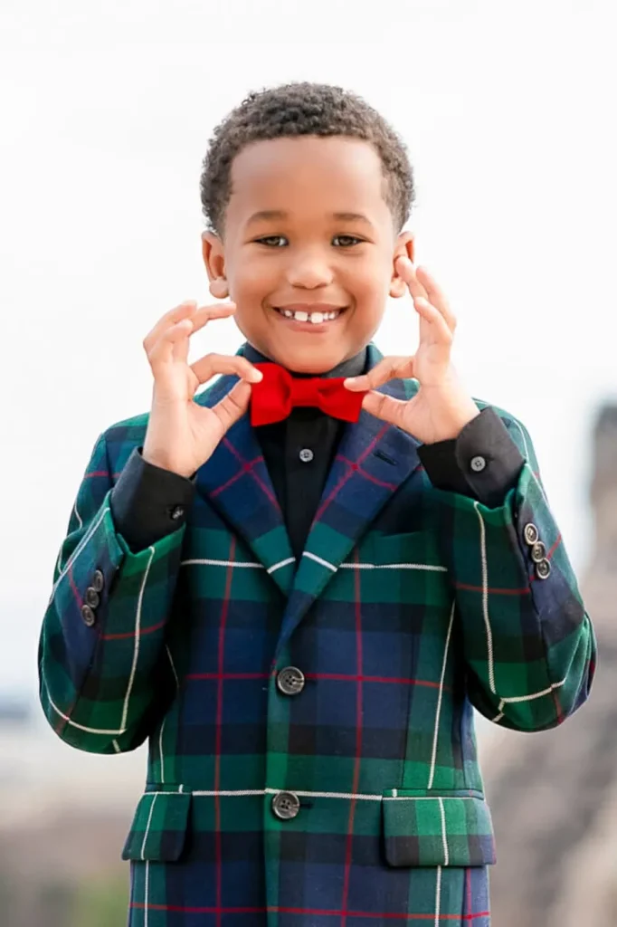Paris family photography featuring young boy in red bowtie at Trocadero sunrise session