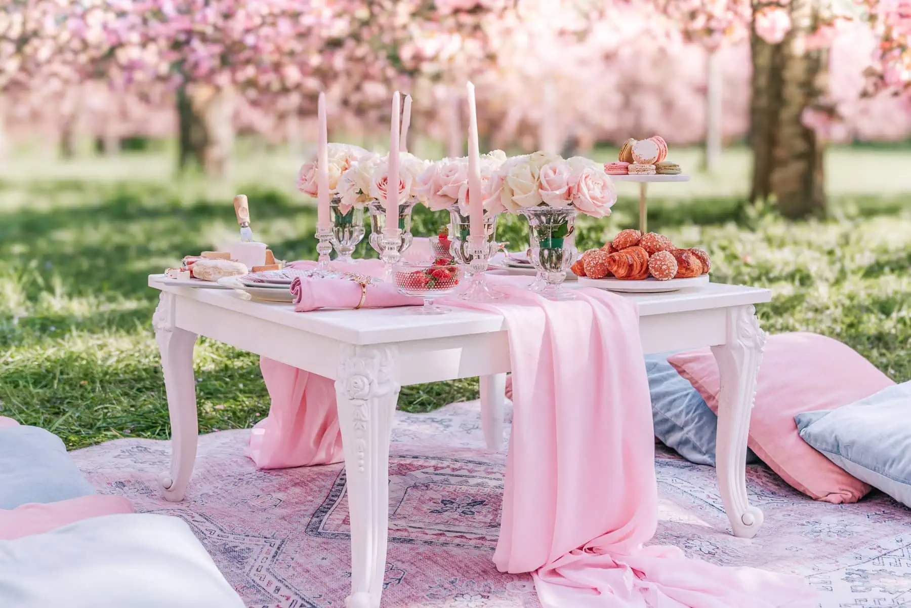 Luxury Paris Picnic Proposal setup with cherry blossoms at Parc de Sceaux featuring gourmet French delicacies and champagne