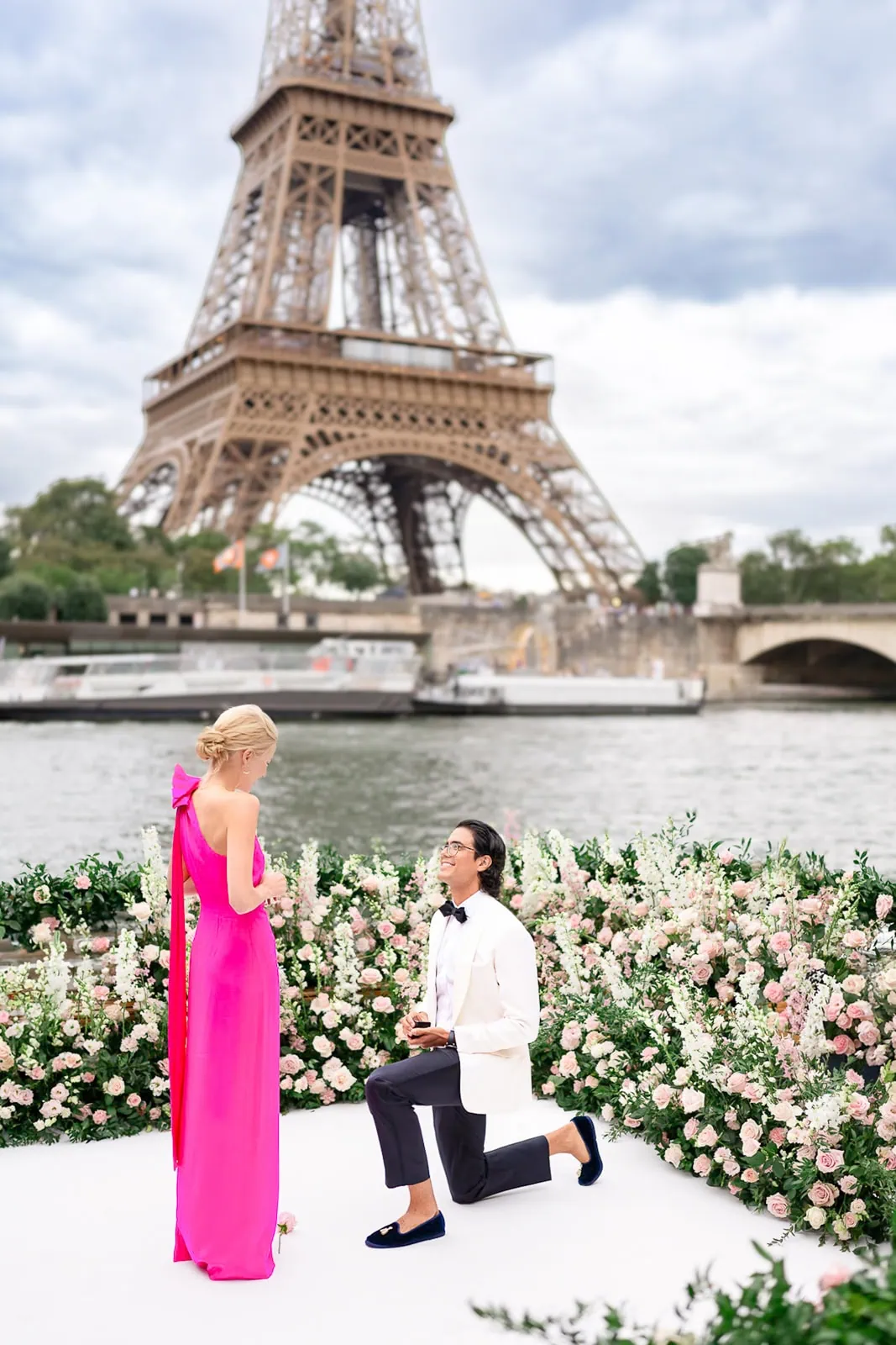 Paris proposal photographer captures private Eiffel Tower engagement on a luxury yacht on the Seine with floral decor