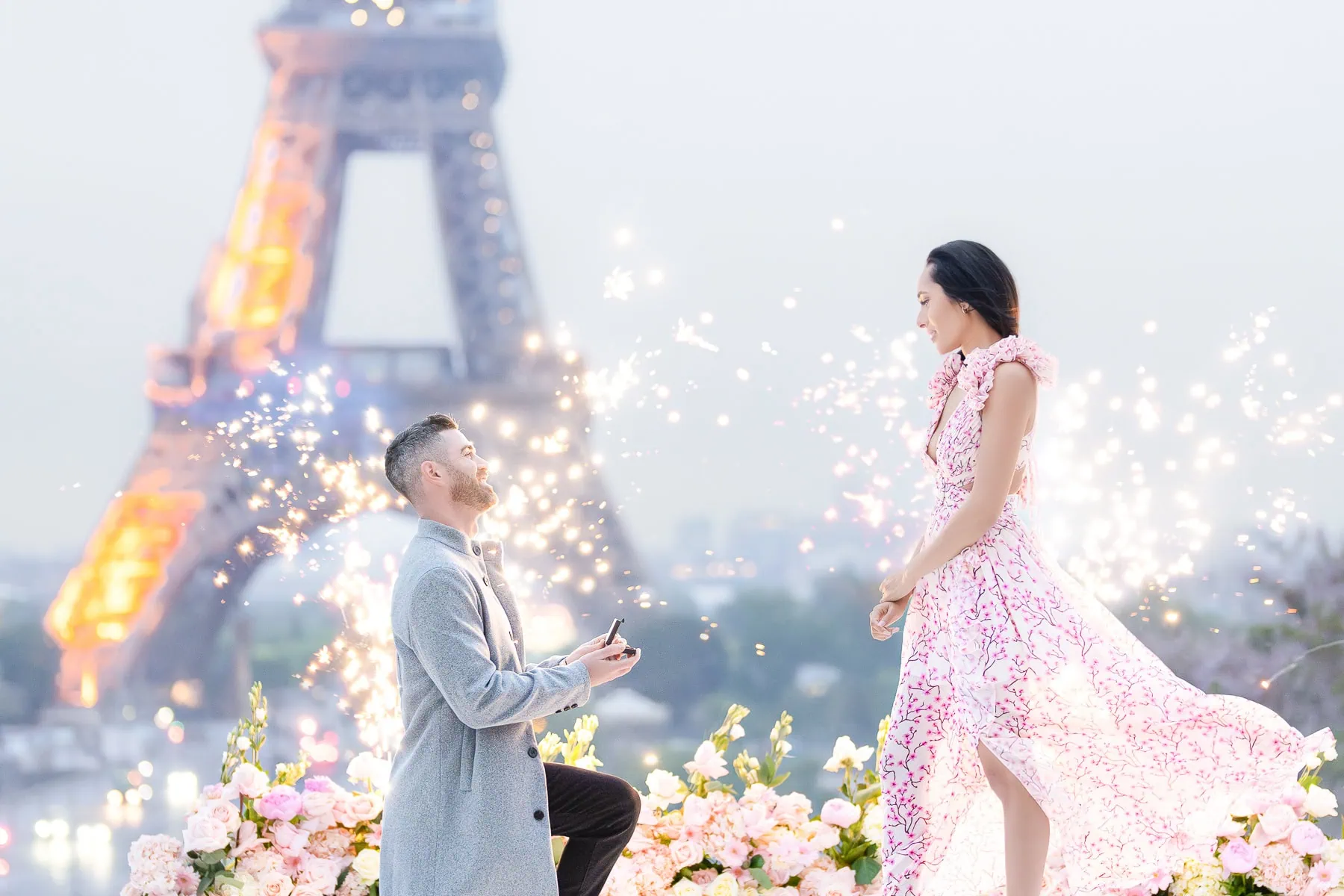 Paris proposal photographer captures sunrise engagement at Trocadéro with Eiffel Tower, fireworks, and romantic floral setup