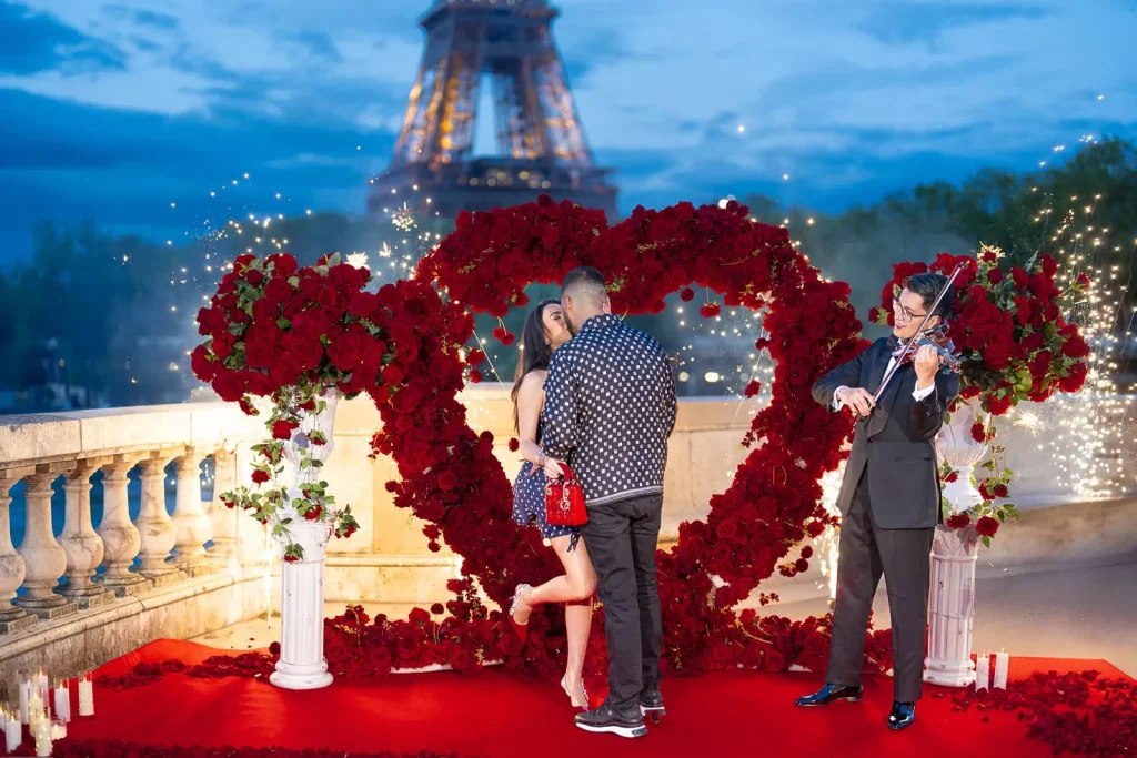 Paris proposal photography at Bir-Hakeim Bridge with Eiffel Tower, heart display, fireworks fountains, and violinist.